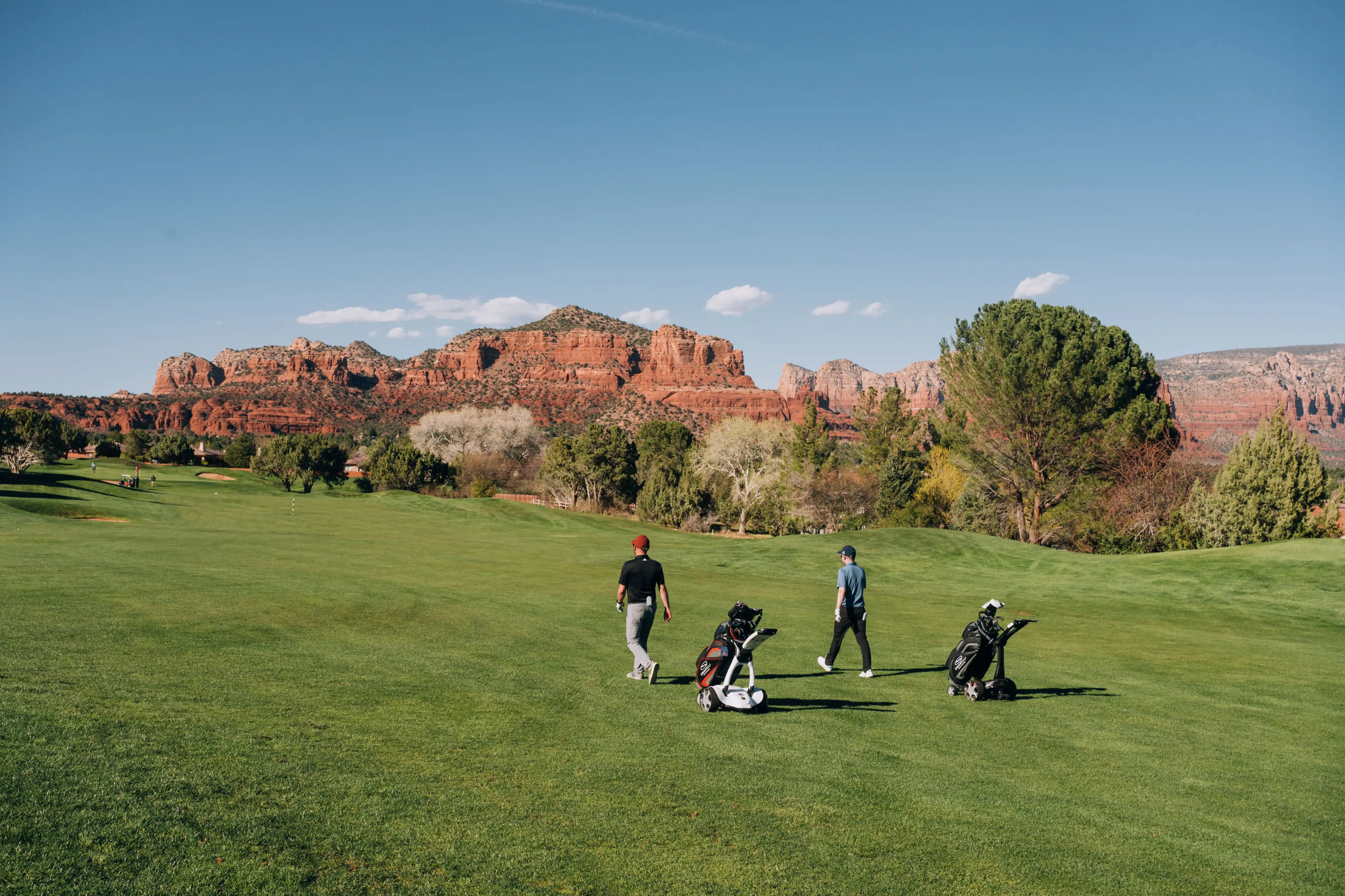 Golfers walking on a scenic golf course