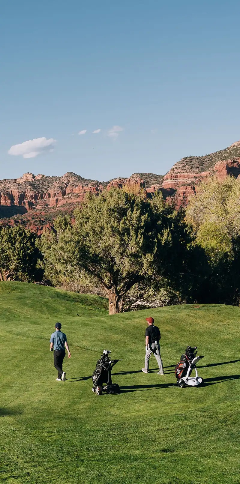 Golfers walking on a scenic golf course
